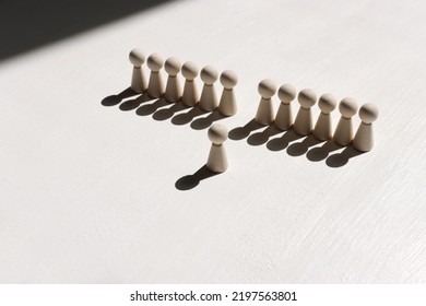 Concept Image Of Wooden Figures Forming A Wall. Leadership Teamwork And Strength Metaphor