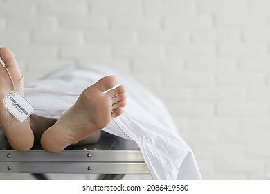 Concept Imitation Morgue, Coronavirus Victim Killed By 2019-ncov, Legs Of A Corpse On A Table, Man Died