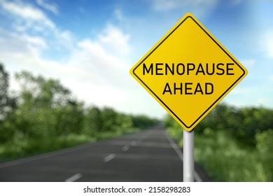 Concept of impending climacteric. Sign MENOPAUSE AHEAD near asphalt road outdoors - Shutterstock ID 2158298283