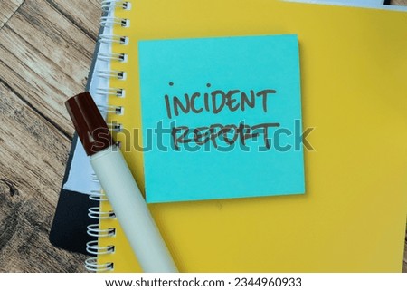 Concept of Incident Report write on sticky notes isolated on Wooden Table.
