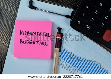 Concept of Incremental Budgeting write on sticky notes isolated on Wooden Table.