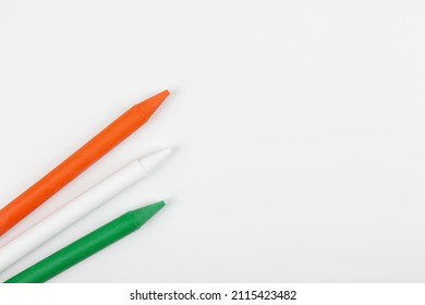 Concept Independence Day of India and India National Day. Wax crayons of Indian flag colors on white background. Flat lay. Copy space.