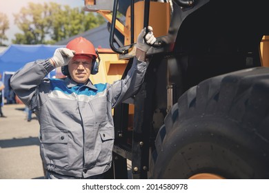 Concept Industry Man Worker. Driver Yellow Big Truck On Coal At Open Pit Mining.