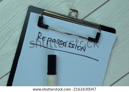 Concept of Info About Repossession write on a paperwork isolated on Wooden Table. Selective focus on Repossession text