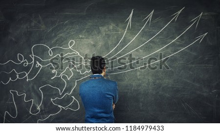 Concept of information processing as a concentrated businessman thinking in front of a huge blackboard as mesh lines come through head and transform into straight arrows as project ideas.