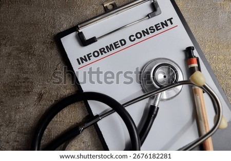 Concept of informed consent write on clipboard isolated on Wooden Table.