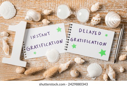Concept of instant gratification versus delayed gratification. Text on paper decorated with seashells indoors studio shot.