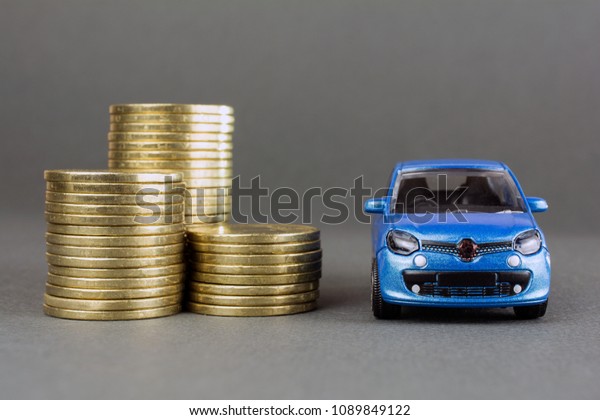 concept of insurance, credit and car purchases,\
leasing, car loan,  Auto dealership and rental, new car buy. toy\
car stack of coins
