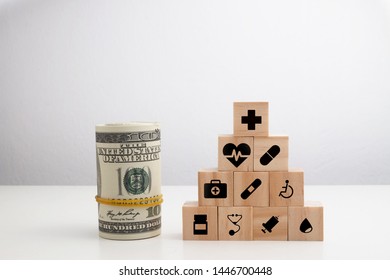 Concept Of Insurance For Your Health On Wooden Block With Healthcare Medical icon And Fake Money.