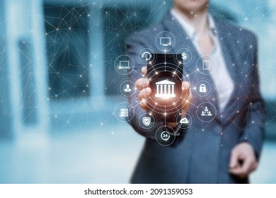 The Concept Of Integrating A Bank Into An Internet. Businesswoman Shows An Internet Bank On A Blurred Background.