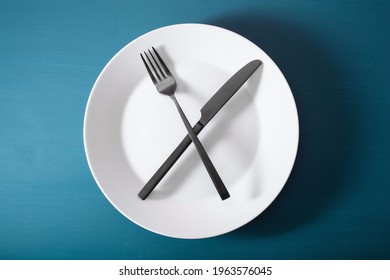 Concept Of Intermittent Fasting, Ketogenic Diet, Weight Loss. Fork And Knife On Plate