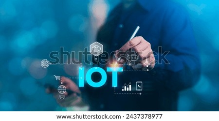 Concept of Internet of Things (IoT), technology, innovation, business and development, A man touching a virtual screen displaying "IOT"
