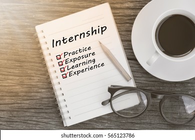 Concept Internship benefits message on notebook with glasses, pencil and coffee cup on wooden table. - Powered by Shutterstock