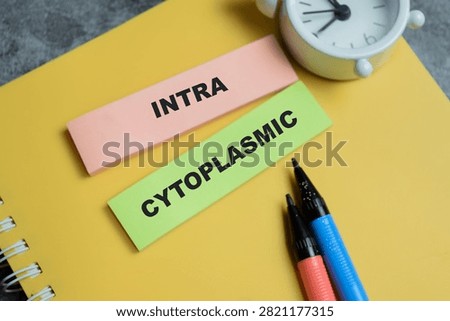 Concept of intra cytoplasmic write on sticky notes isolated on Wooden Table.
