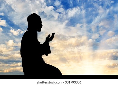 Concept Of Islam Is The Religion. Silhouette Of Man Praying At Sunset