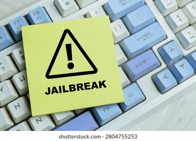 Concept of jailbreak write on sticky notes isolated on Wooden Table. For device freedom security restriction system access privilege escalation digital rights technology control