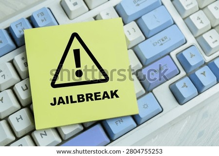 Concept of jailbreak write on sticky notes isolated on Wooden Table. For device freedom security restriction system access privilege escalation digital rights technology control