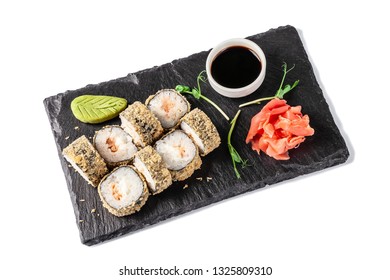 Concept Of Japanese Cuisine. Deep Fried Roll With Salmon And Mayonnaise In Panko Bread Crumbs. Near Soy Sauce, Ginger And Wasabi. Modern Serving Dishes In The Restaurant On A Black Slate Blackboard. 