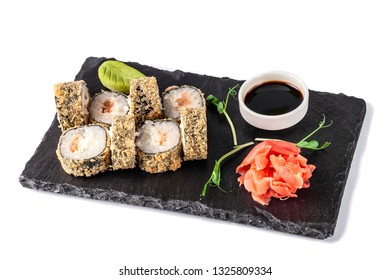 Concept Of Japanese Cuisine. Deep Fried Roll With Salmon And Mayonnaise In Panko Bread Crumbs. Near Soy Sauce, Ginger And Wasabi. Modern Serving Dishes In The Restaurant On A Black Slate Blackboard. 