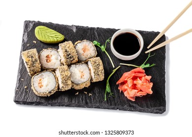 Concept Of Japanese Cuisine. Deep Fried Roll With Salmon And Mayonnaise In Panko Bread Crumbs. Near Soy Sauce, Ginger And Wasabi. Modern Serving Dishes In The Restaurant On A Black Slate Blackboard. 