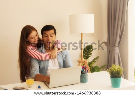 Concept  joyful family : Happiness of two people, father and daughter, embracing tease together in the work room in the house, makes my father like it.

