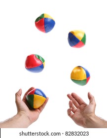 Concept for juggling priorities, 5 balls being thrown by pair of hands over white blurred motion on balls