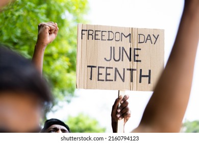 concept of Juneteenth freedom day march showing by close up protesting hands sign board - concept of activism, justice and demonstration - Shutterstock ID 2160794123