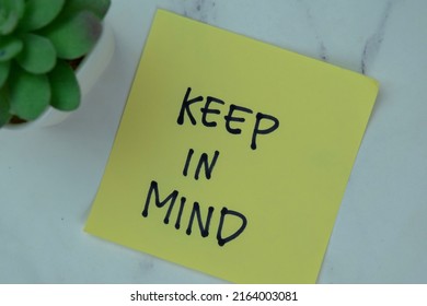 Concept of Keep in Mind write on sticky notes isolated on Wooden Table. - Shutterstock ID 2164003081