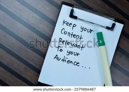 Concept of Keep Your Content Relevant To Your Audience write on paperwork isolated on Wooden Table.