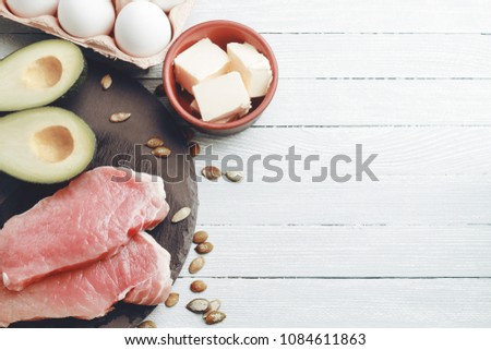 Concept of ketogenic diet. Dietary food on light table