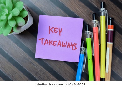 Concept of Key Takeaways write on sticky notes isolated on Wooden Table.