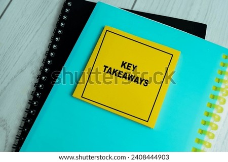Concept of Key Takeaways write on sticky notes isolated on Wooden Table.