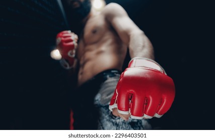 Concept kickboxing sport banner, dark color. Closeup red Gloves for MMA of Boxers fighter in octagon.