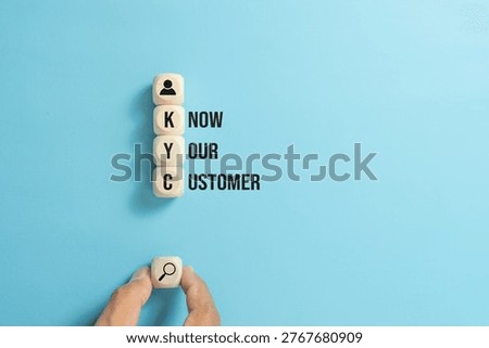 Concept know your customer or KYC. Text and icons on wooden cubes or dice.