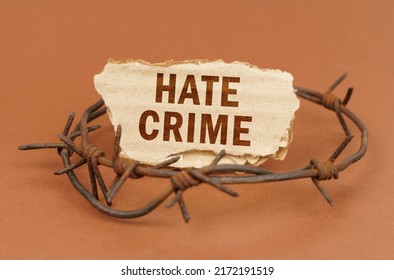 The Concept Of Law And Crime. On A Brown Surface, Barbed Wire And A Cardboard Sign With The Inscription - Hate Crime