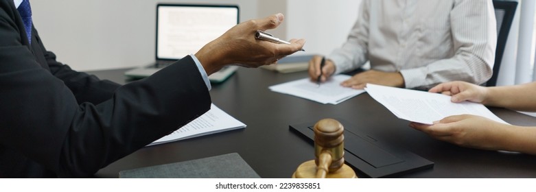 Concept of lawyer counseling, Senior lawyer provides advice to couple about their divorce agreement. - Shutterstock ID 2239835851