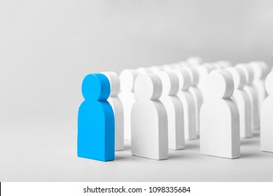 Concept leader of the business team indicates the direction of the movement towards the goal. Crowd of white men goes for the leader of the blue color - Shutterstock ID 1098335684