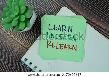 Concept of Learn, Unlearn, Relearn Continuous Learning write on sticky notes isolated on Wooden Table.