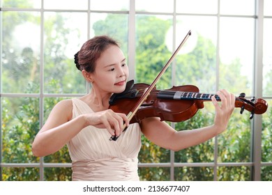 Concept Of Learning Classical Music. Asian Woman Playing Violin Classical Musical Instruments. Teacher Teaching Students In Art School