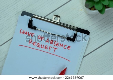 Concept of Leave of Absence Request write on paperwork isolated on Wooden Table.