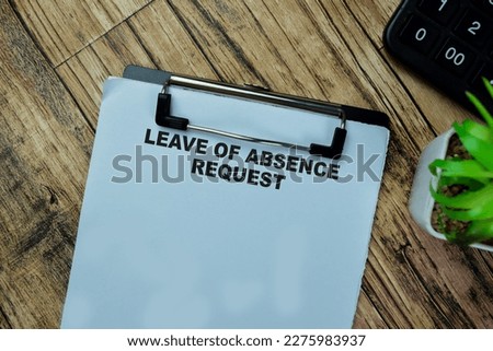 Concept of Leave of Absence Request write on paperwork isolated on Wooden Table.