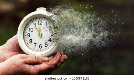 The concept of leaving time. Old hours, in old hands. Old alarm clock. Vintage clock as time passing and pass away concept - Shutterstock ID 1050971186