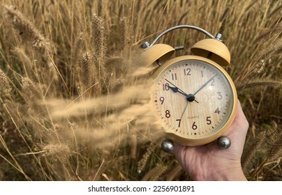The concept of leaving time. Old hours, in hands. Old alarm clock. Vintage clock as time passing and pass away concept