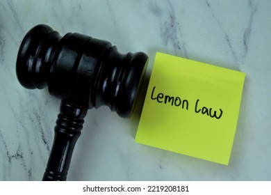 Concept of Lemon Law write on sticky notes with gavel isolated on Wooden Table. - Shutterstock ID 2219208181