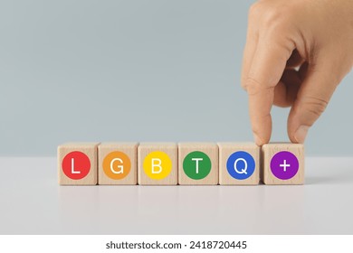 Concept of LGBTQ rights and law. pride month celebrate annual in June social of gay, lesbian, bisexual, transgender, human rights. Hand arranged wooden cube with text in multicolor circle  - Powered by Shutterstock