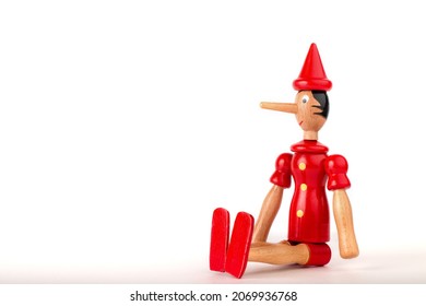 The concept of lies. Pinocchio's nose. Dishonest person caught being dishonest. Corruption, fake allegations, politicians. Wooden puppet. - Shutterstock ID 2069936768