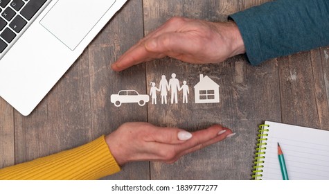 Concept Of Life, Auto And Home Insurance With Hands In A Protective Gesture