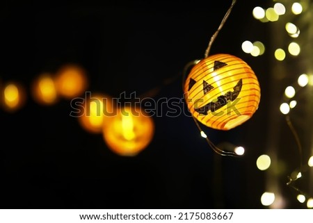 The concept of light on the night Halloween.Round lamp shape of pumpkin used to decorate with copy space for text.
