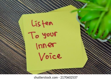 Concept of Listen To Your Inner Voice write on sticky notes isolated on Wooden Table. - Shutterstock ID 2170602537