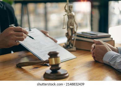 concept of litigation and justice Attorneys work with legal advisors. Punishing the defendant in the courtroom Businessman and male lawyer talking with client in office - Shutterstock ID 2148832439